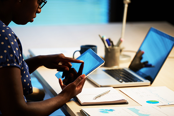 Cropped image of business woman using app on her tablet
